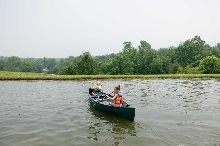 camp children in canoe on lake